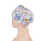 Side back view of blue butterfly scrub cap with pink, yellow flowers