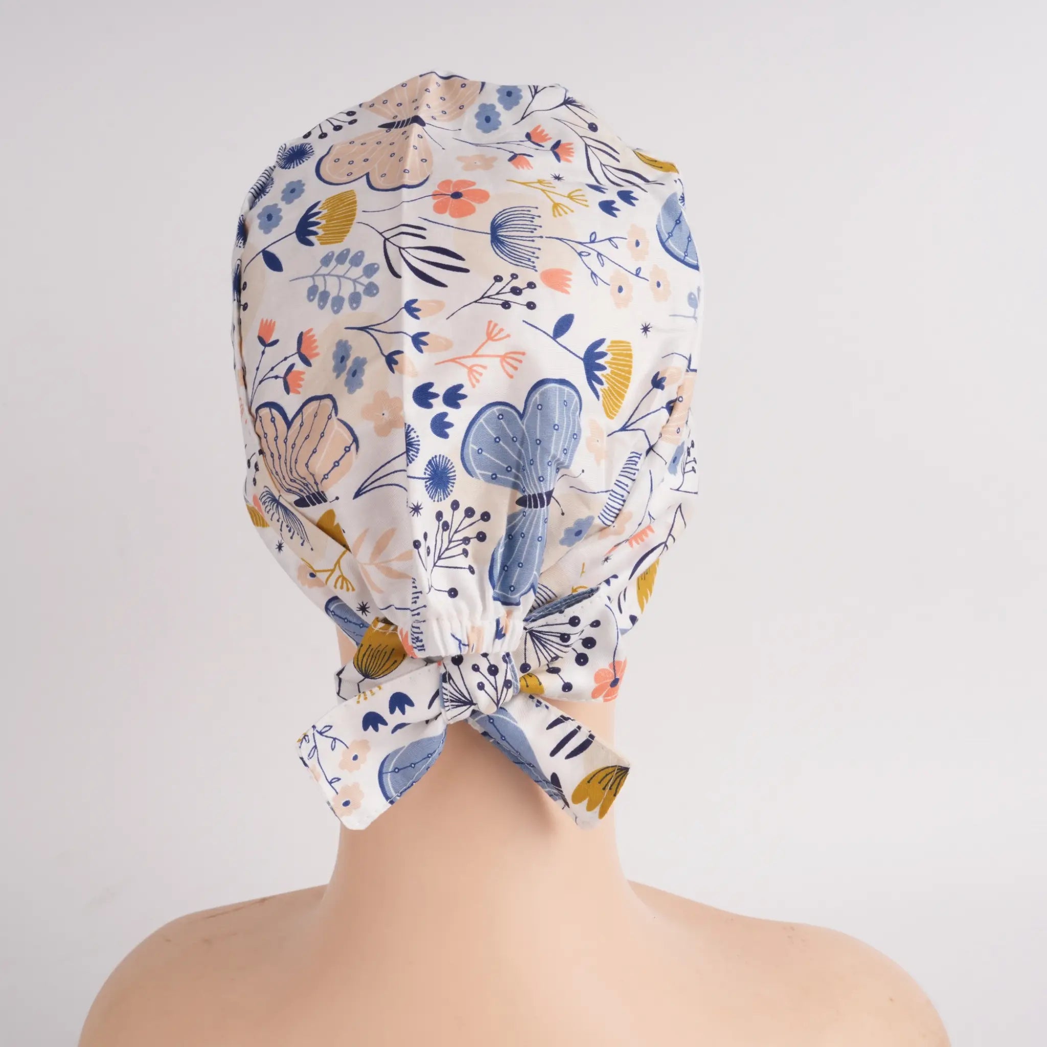 Back view of blue butterfly tie back scrub cap showing tie bow detail 
