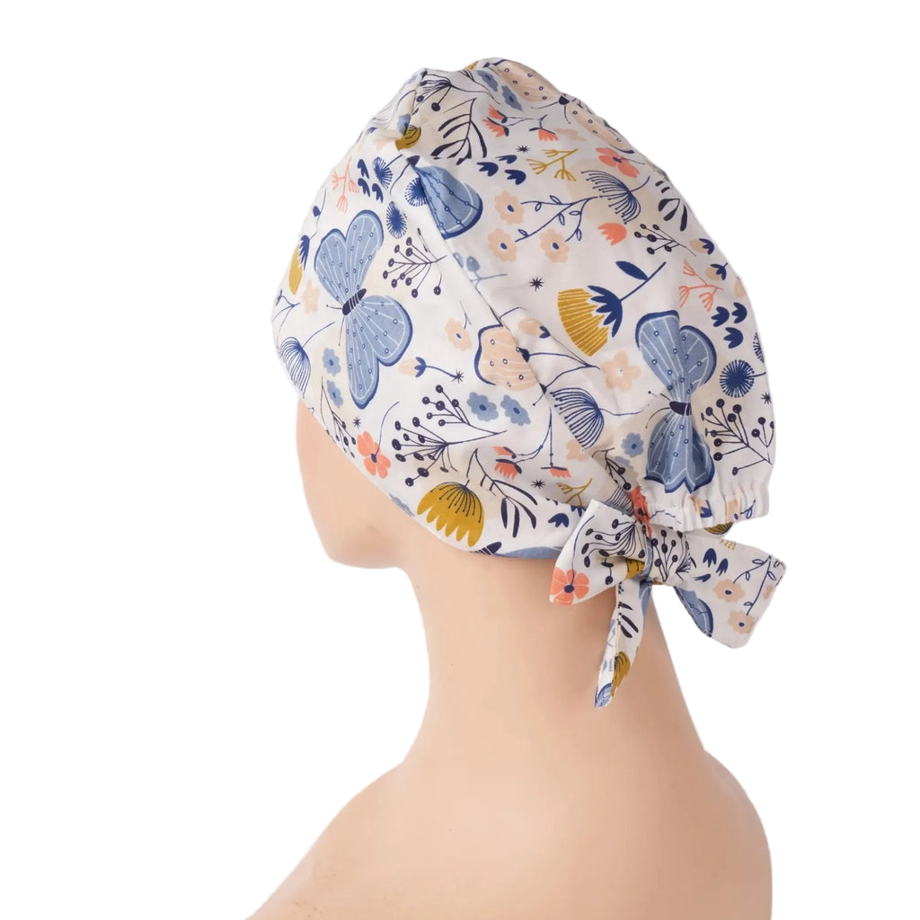 Side back view of a tie back scrub cap with blue butterflies and flowers