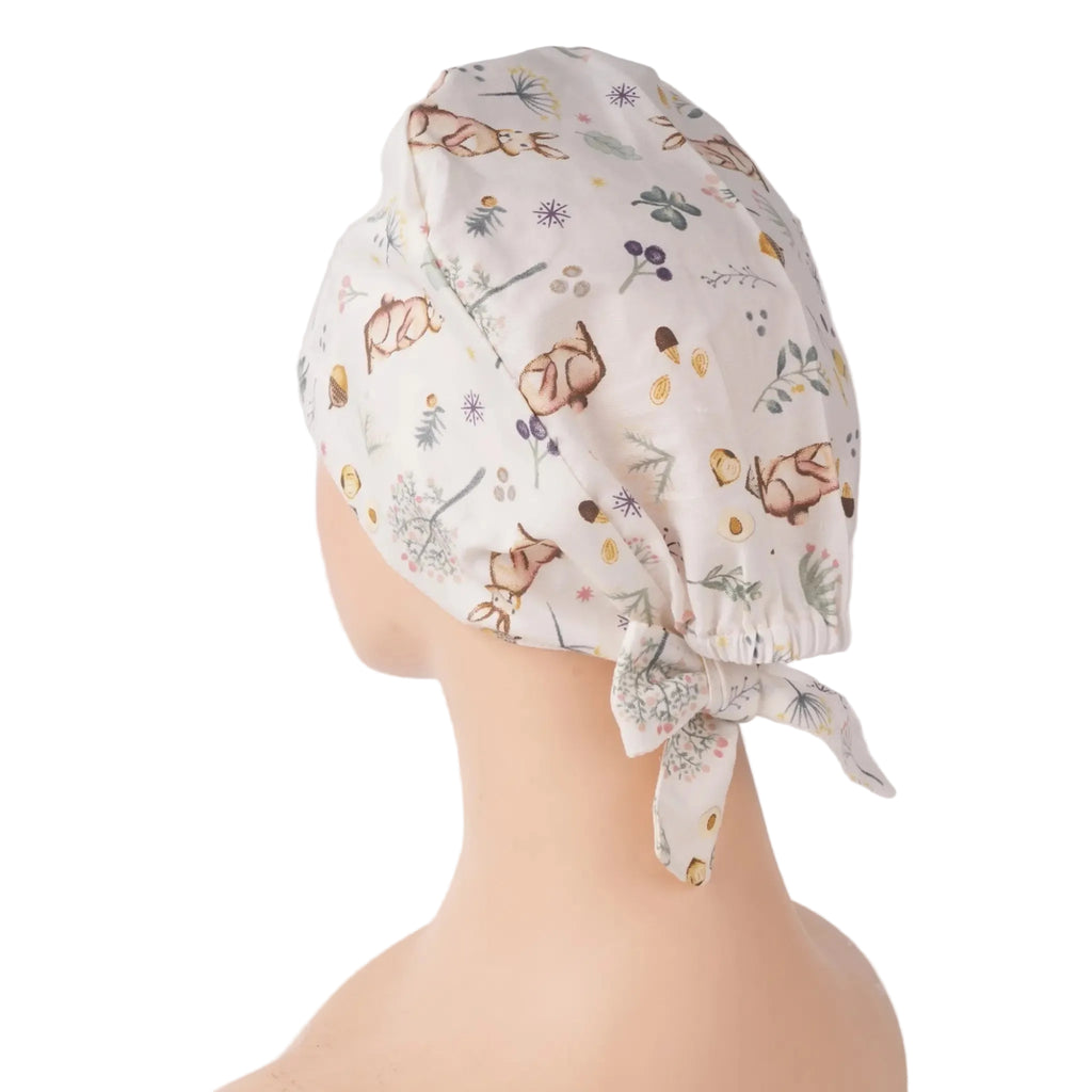 Side view of white bunny print scrub cap with leaves and flowers pattern