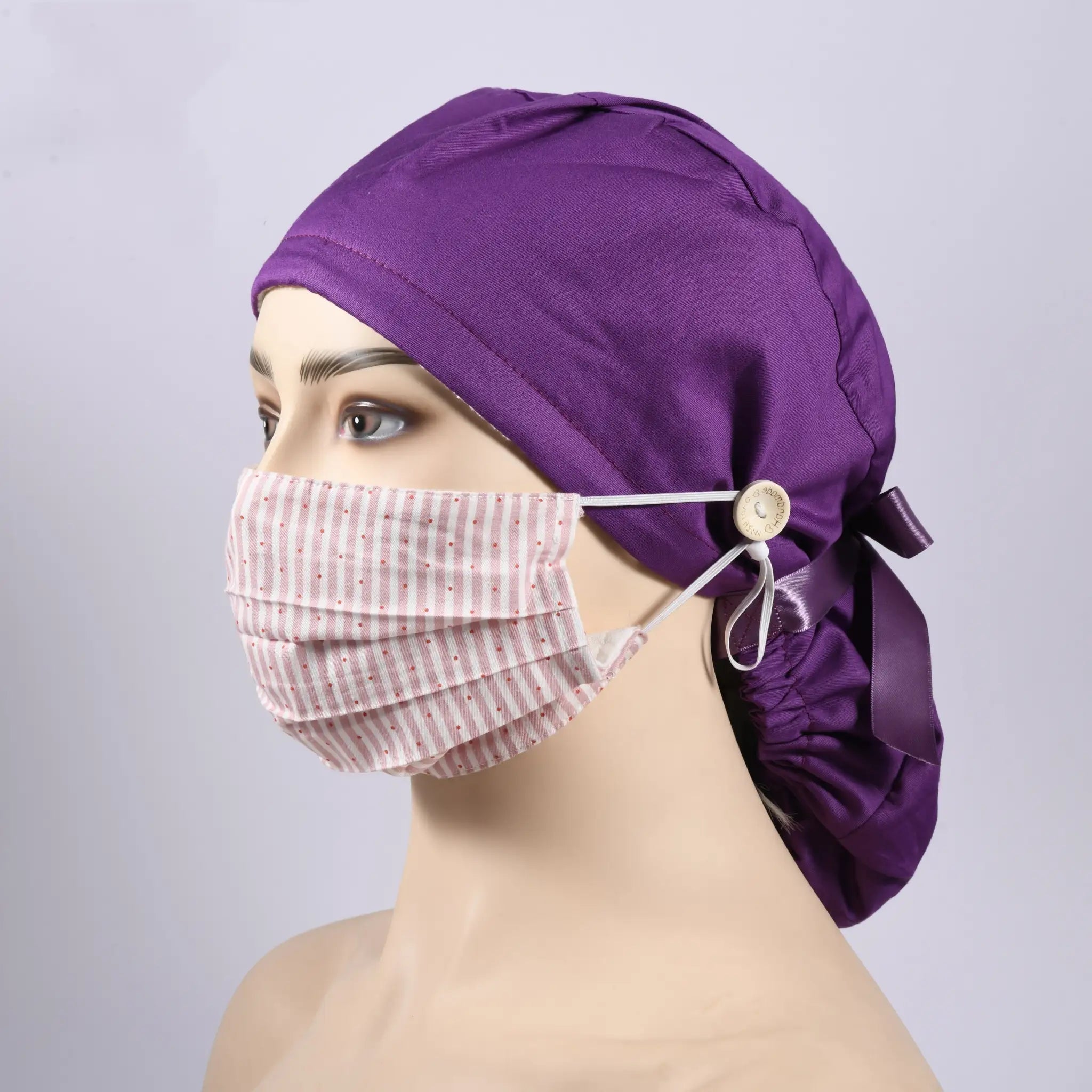 Left-side view of a mannequin head wearing a dark purple ponytail hat and a mask.