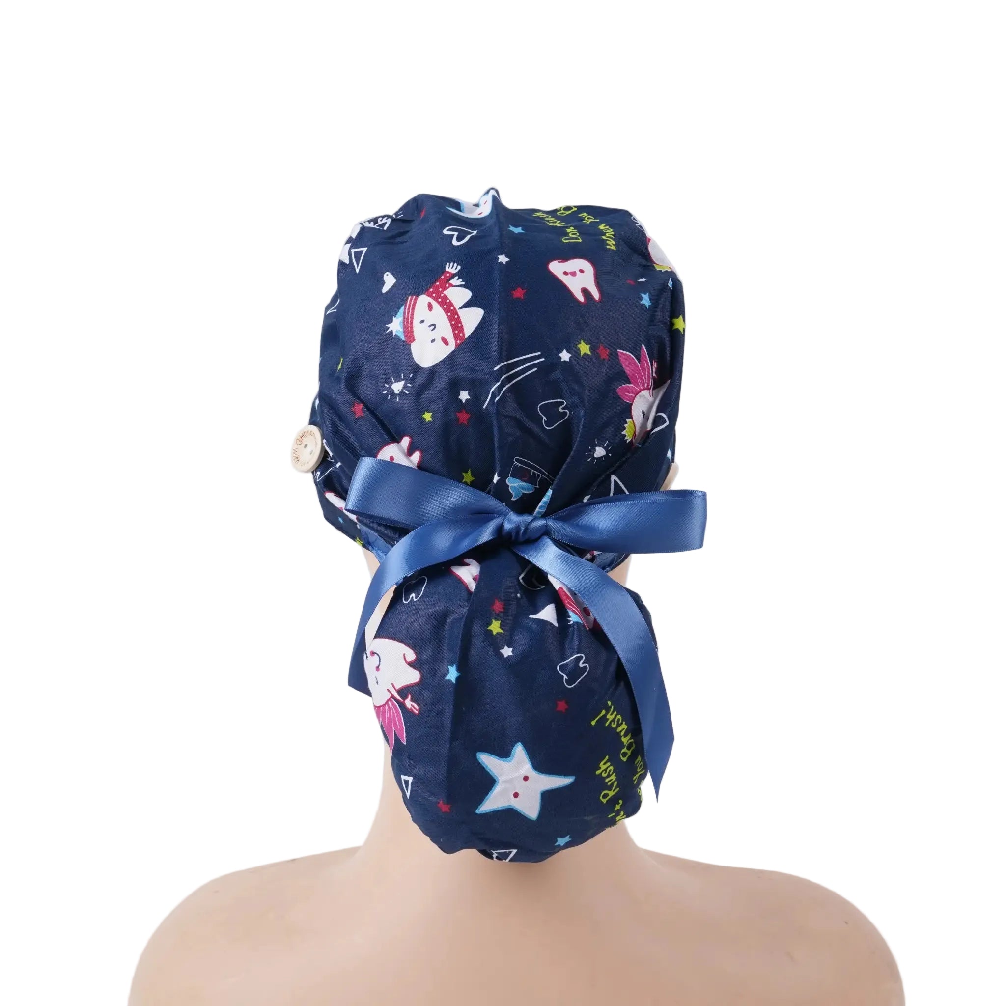 Navy blue dental-themed scrub cap with cartoon tooth, rabbit, and star prints, satin ribbon bow at back