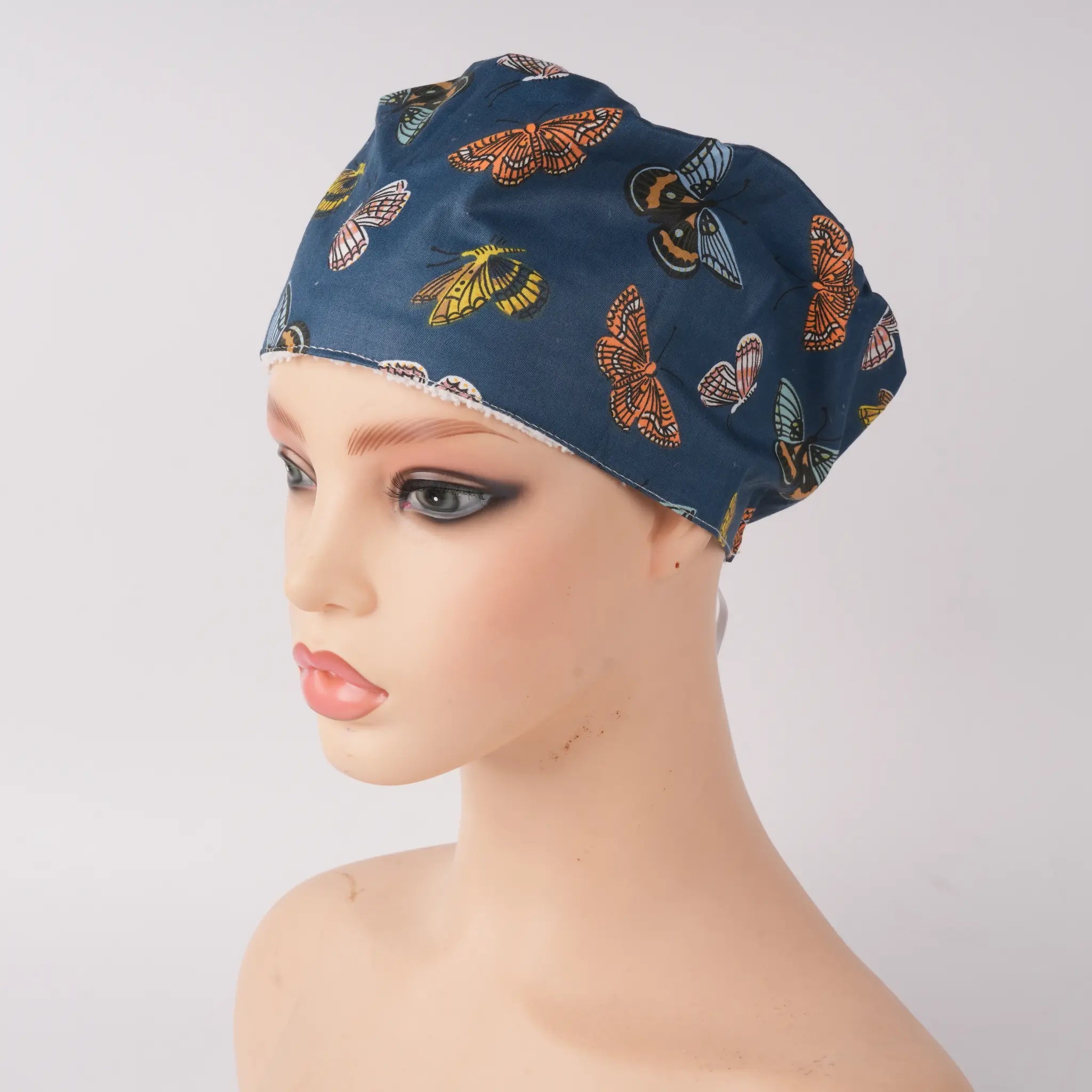 Front view of navy butterfly euro cap on mannequin head