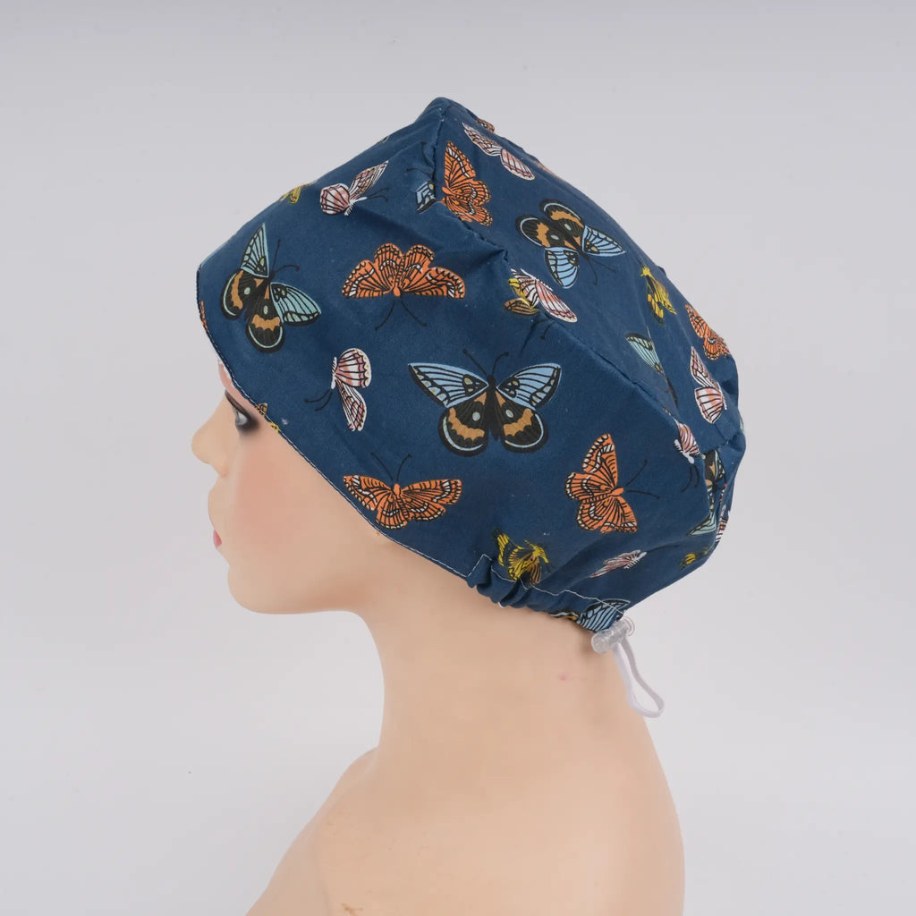 Left side view of navy butterfly euro cap on mannequin head