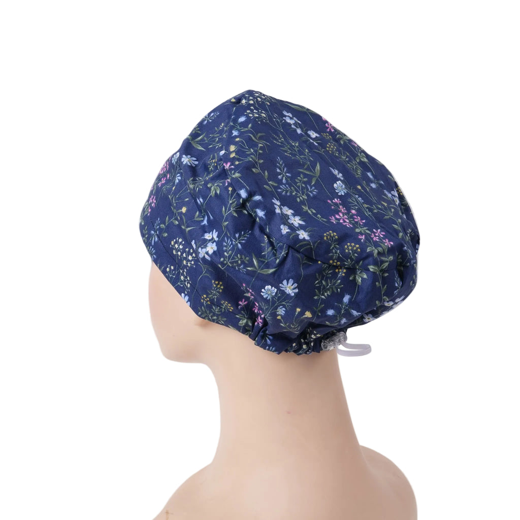 Navy floral euro scrub cap shown on a mannequin head from a side-back angle with adjustable back cord.
