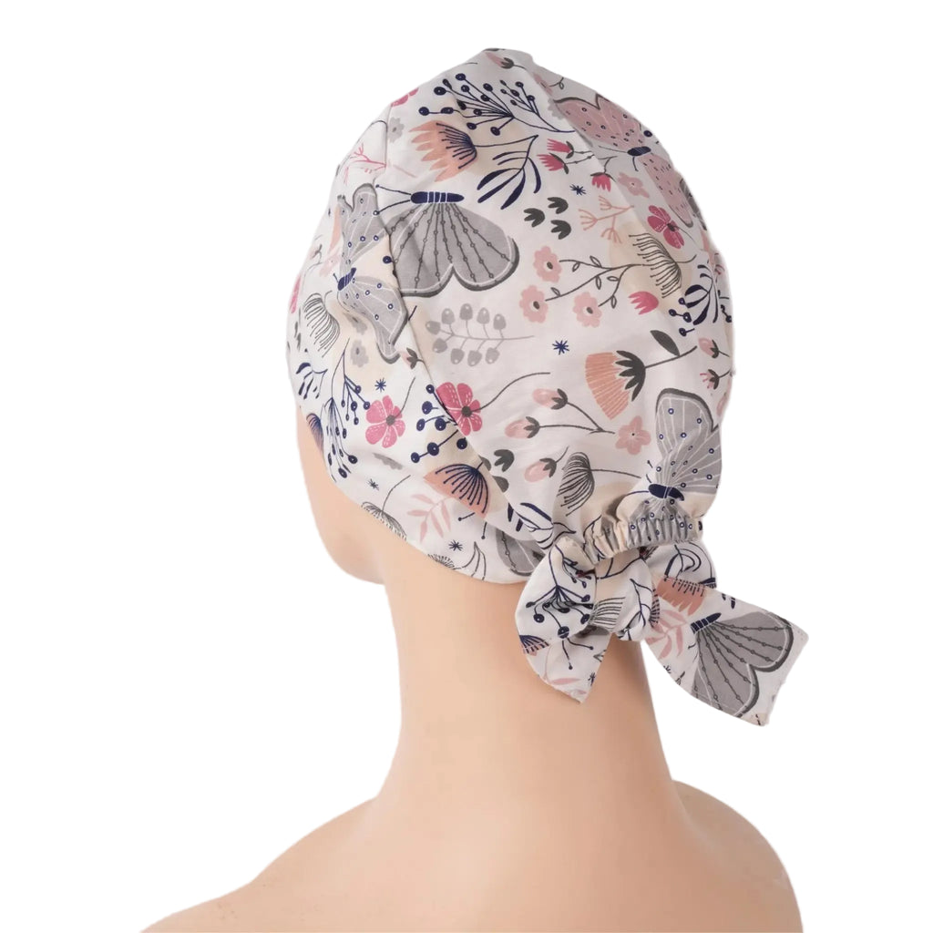 Side back view of gray butterfly tie back scrub cap with pink flowers