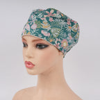 Front view of teal green floral euro cap on mannequin head.