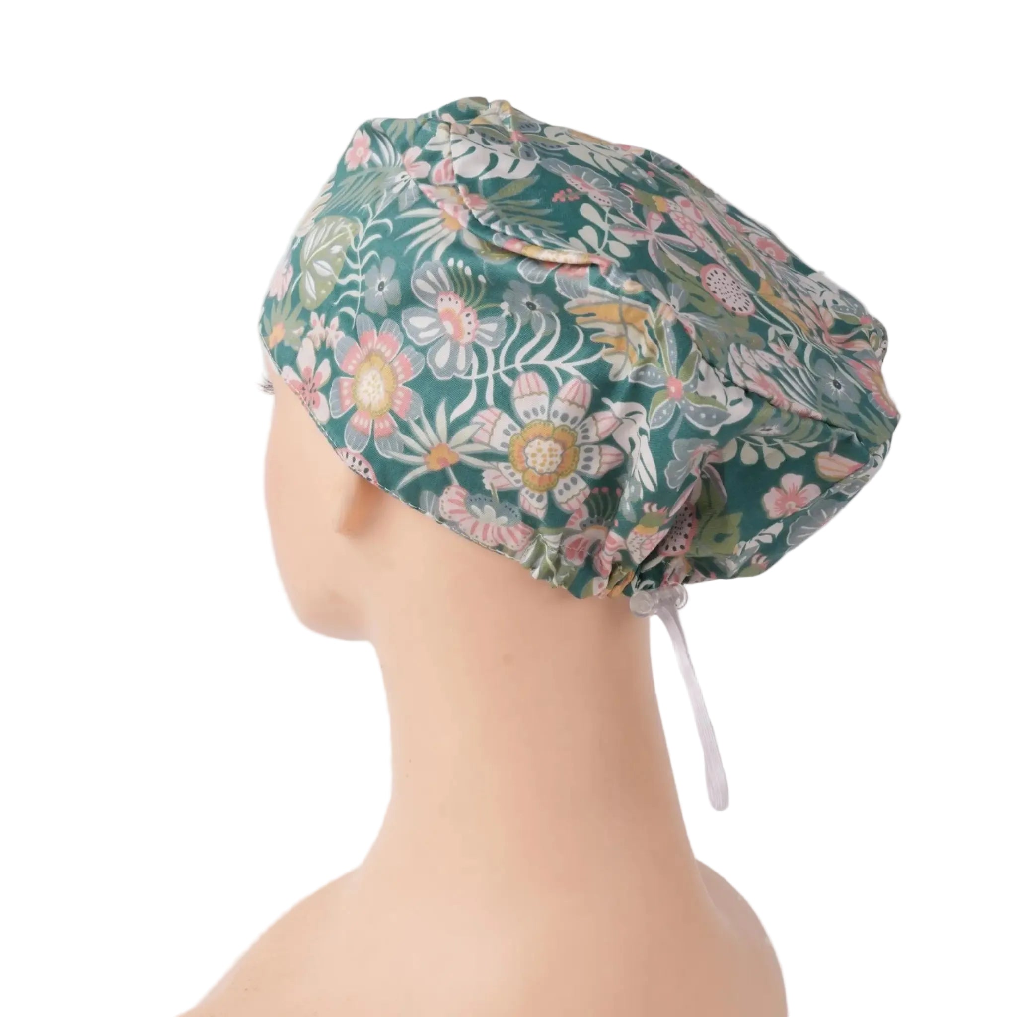 A euro scrub cap in teal green with pink, white, and yellow flowers, shown on a mannequin head.