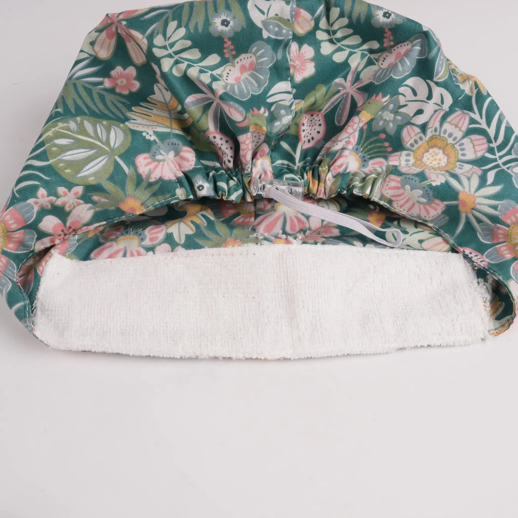Close-up of forehead sweatband on teal green floral euro cap.