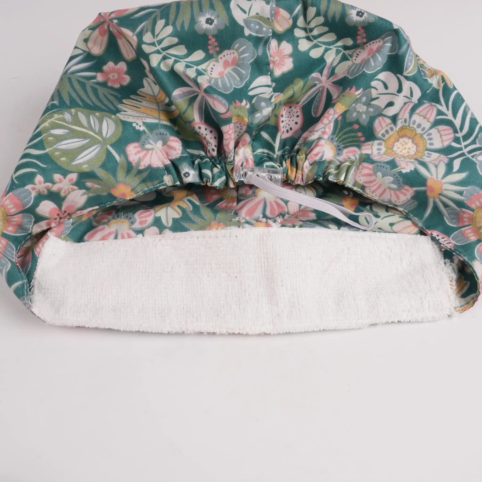 Close-up of forehead sweatband on teal green floral euro cap.