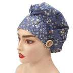 Side front view of navy floral bouffant cap on mannequin head
