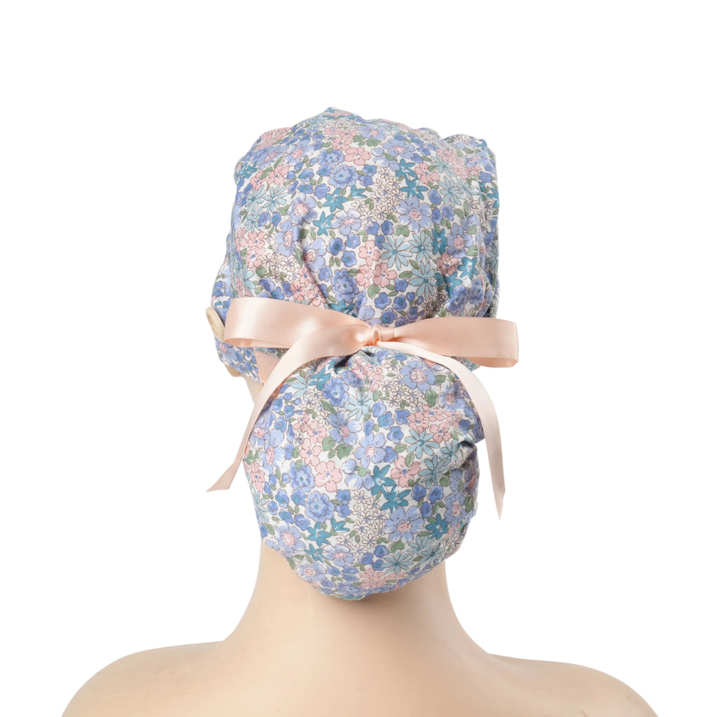 Back view of a pink blue ponytail cap with light pink ribbon