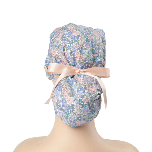 Back view of a pink blue ponytail cap with light pink ribbon