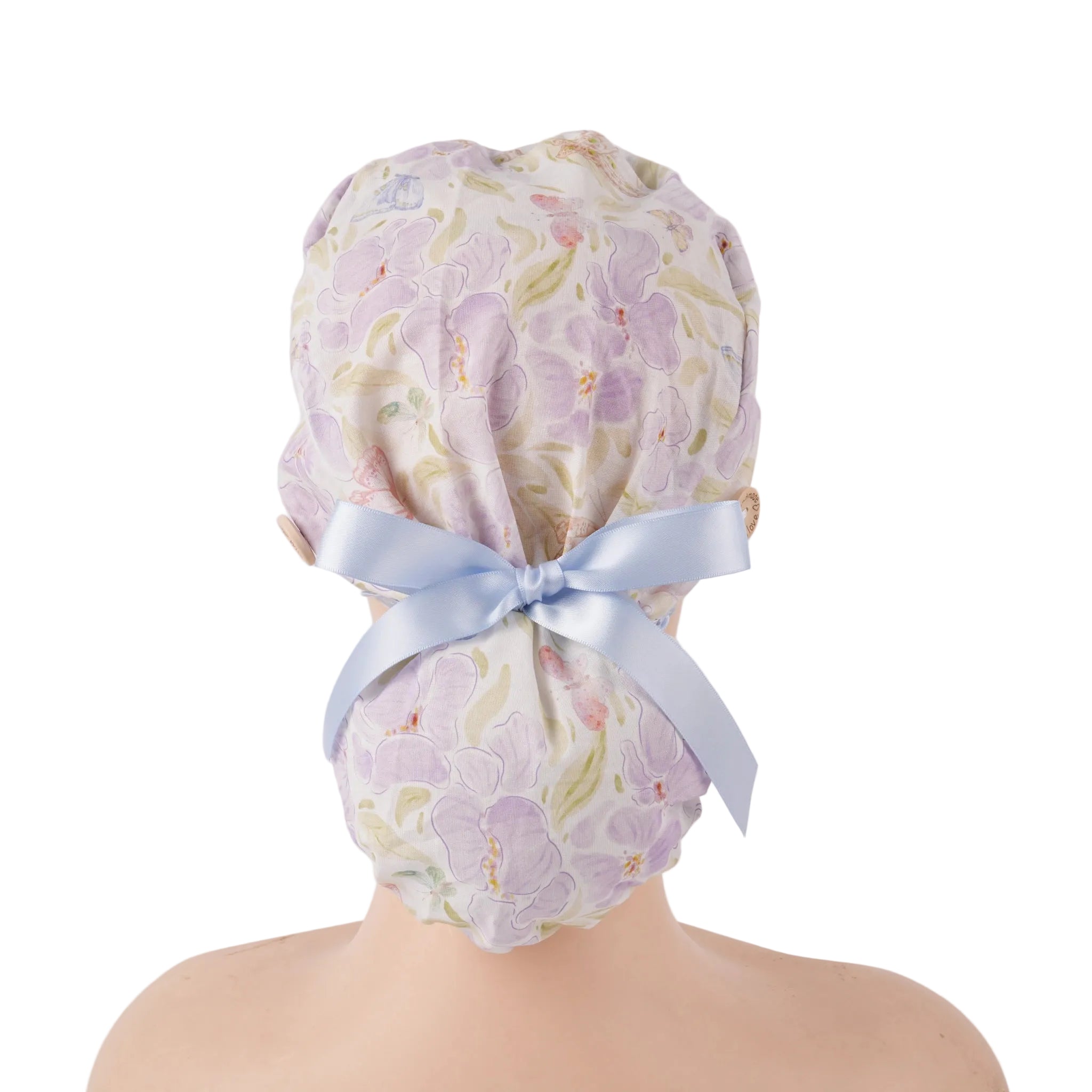 Lavender iris floral ponytail scrub cap with light blue ribbon bow, back view