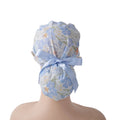 Ocean sea life ponytail scrub cap, shown on a mannequin head, back view with light blue ribbon bow.