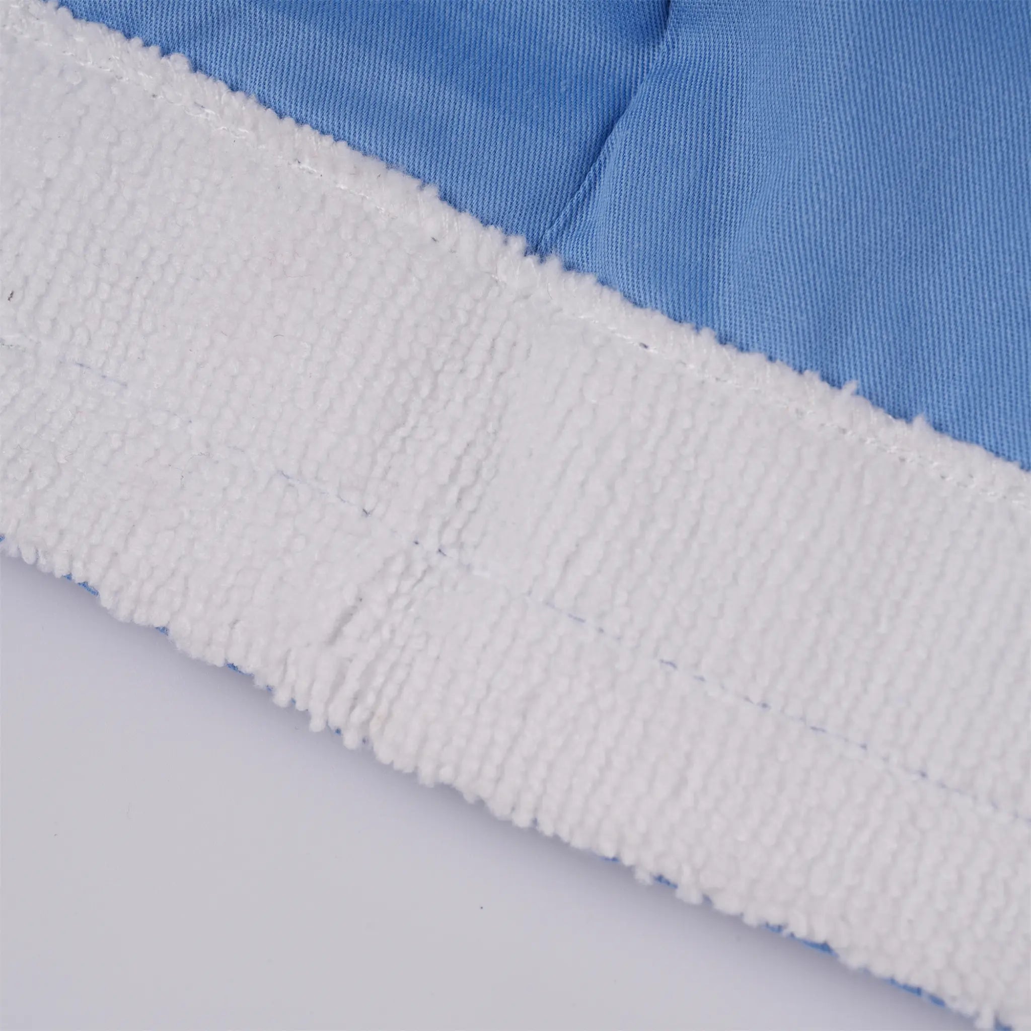 Close-up of white textured sweatband along the forehead edge.