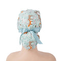 Mint green forest animal print surgical cap with light blue bow, back view