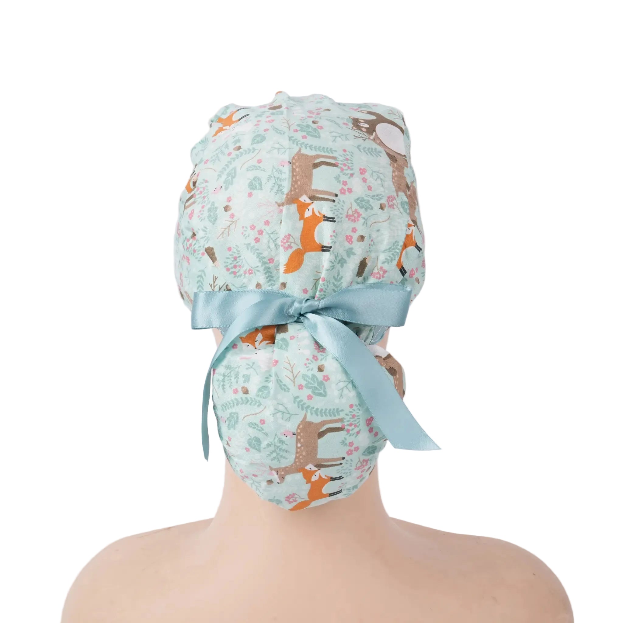 Mint green forest animal print surgical cap with light blue bow, back view