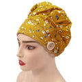Side front view of yellow plum flowers bouffant cap on mannequin head
